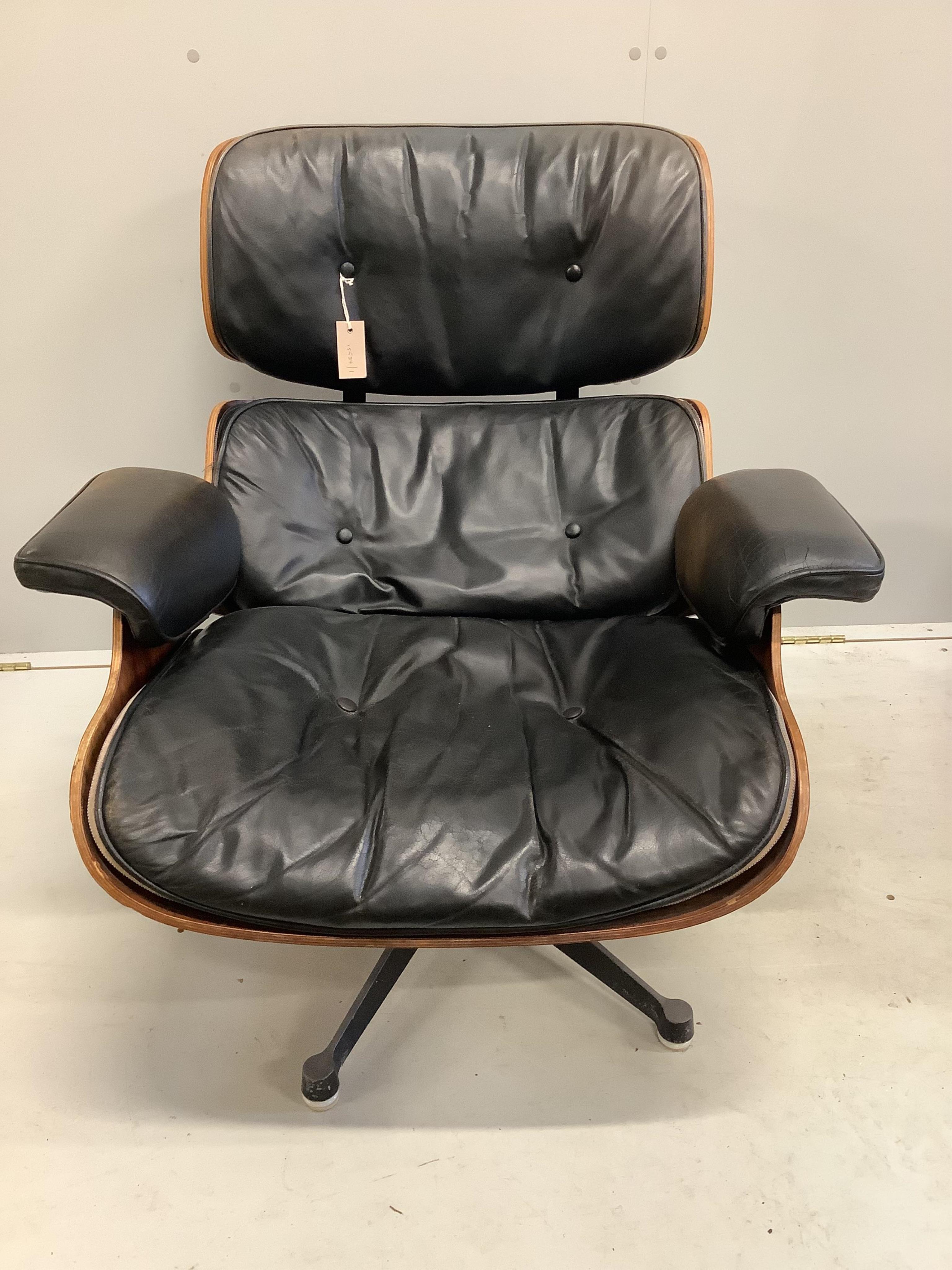 Charles and Ray Eames for Herman Miller Interform, an Indian rosewood and black leather lounge chair and ottoman, circa 1960, chair width 85cm, depth 68cm, height 81cm. Condition - poor to fair